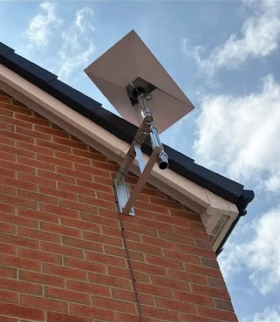 Starlink dish mounted high on a gable end for an unobstructed view of the sky