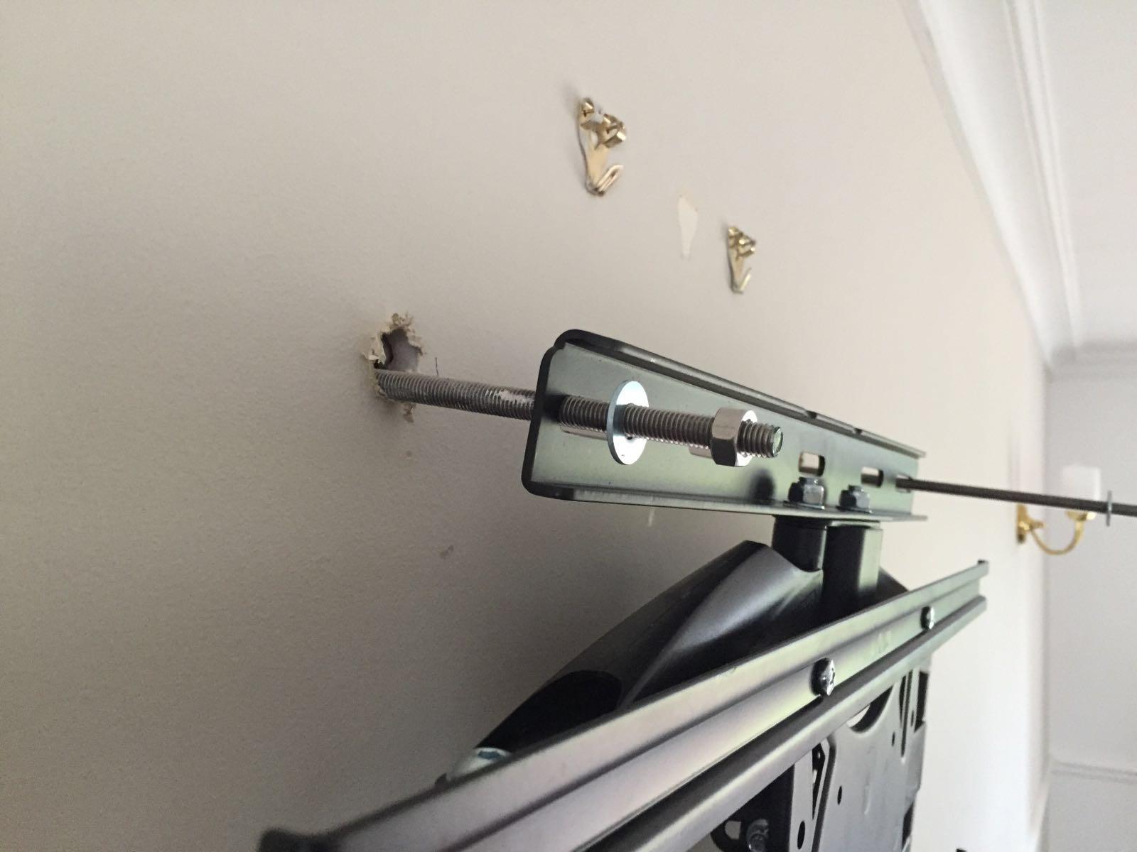 Heavy-duty structural bolt securing a TV mount into a load-bearing wall