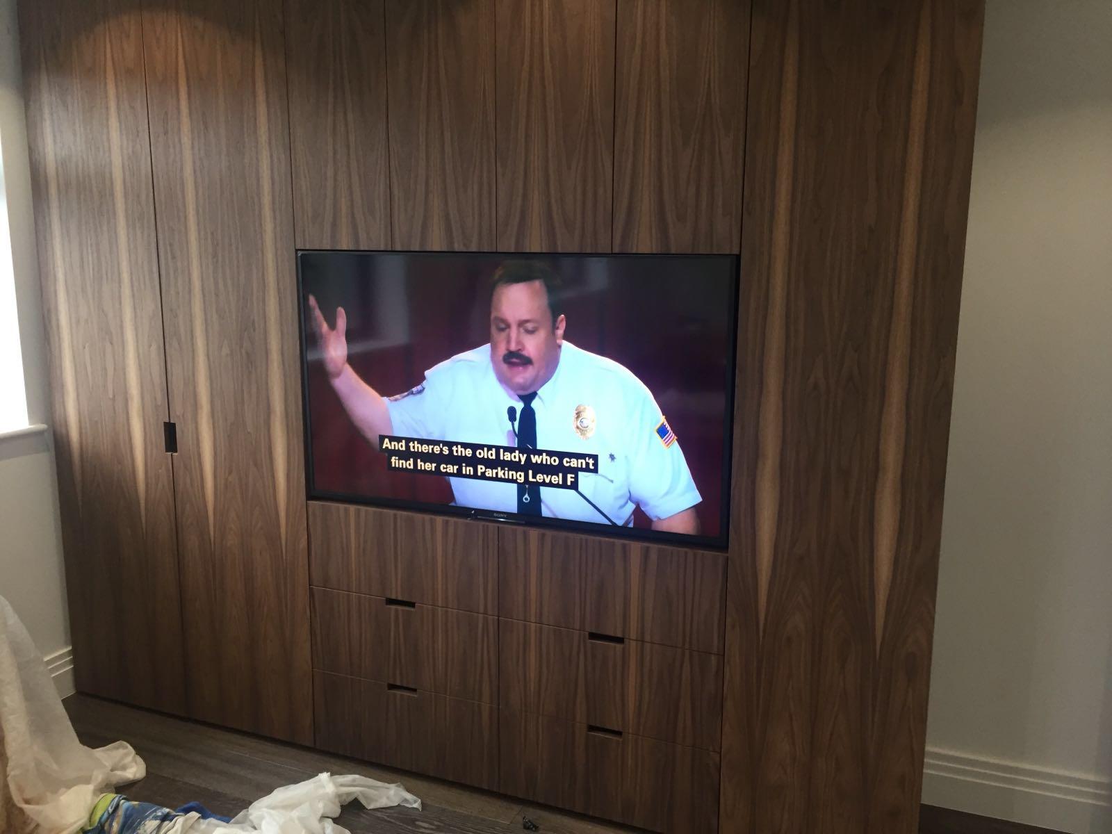 TV integrated into bespoke dark wood cabinetry